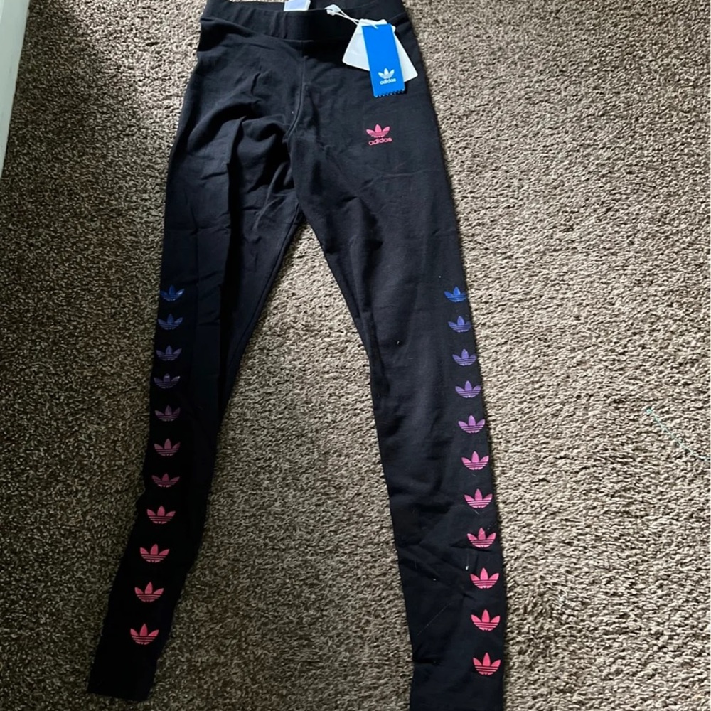 New. Adidas leggings with colorful adidas symbols. Size xs.
